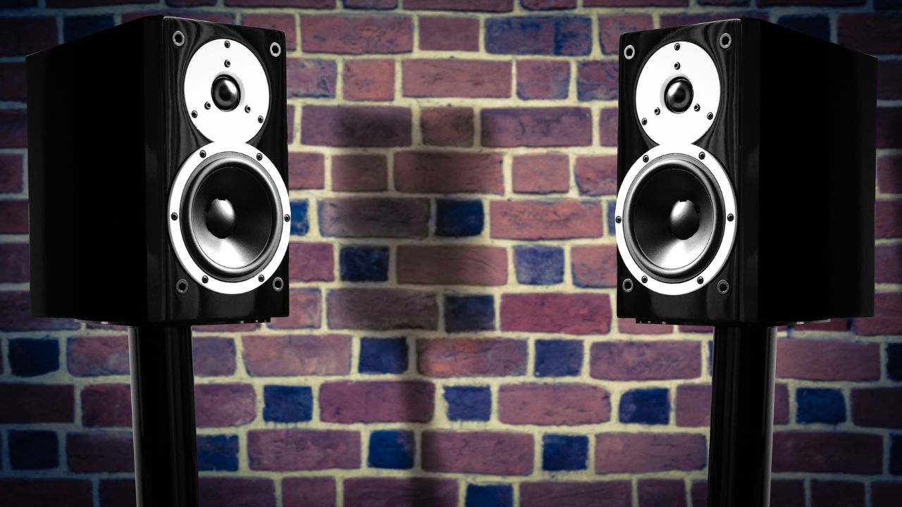 two-speakers-by-brick wall